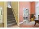 Two-story entryway with a carpeted staircase leading to the upper level and a view of the dining room at 106 Cypress Creek Dr., Murrells Inlet, SC 29576