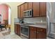 Well-lit kitchen featuring stainless steel appliances, wooden cabinets, and granite countertops at 106 Cypress Creek Dr., Murrells Inlet, SC 29576
