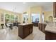 Bright kitchen with an island next to the dining area and a view of the outside patio and living room at 106 Cypress Creek Dr., Murrells Inlet, SC 29576