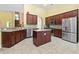 Open kitchen with stainless steel refrigerator, wooden cabinets, an island, and lots of open space at 106 Cypress Creek Dr., Murrells Inlet, SC 29576