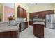 A spacious kitchen featuring wooden cabinets, granite countertops, stainless steel appliances, and a kitchen island at 106 Cypress Creek Dr., Murrells Inlet, SC 29576