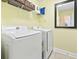 Bright laundry room features modern washer, dryer, and storage shelves for convenience at 106 Cypress Creek Dr., Murrells Inlet, SC 29576