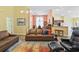 Cozy living room featuring leather sofas, high ceilings, and a view into the adjacent dining and kitchen areas at 106 Cypress Creek Dr., Murrells Inlet, SC 29576