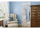 This bedroom features a comfortable armchair with an ottoman and an ensuite bath with shower and walk-in closet at 106 Cypress Creek Dr., Murrells Inlet, SC 29576