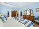 Main bedroom boasts a wooden dresser and light blue walls, complementing the white-and-blue bedspread at 106 Cypress Creek Dr., Murrells Inlet, SC 29576