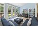 Bright sunroom with a view of the backyard through sliding glass doors and a comfortable seating arrangement at 106 Cypress Creek Dr., Murrells Inlet, SC 29576