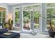 Bright sunroom with open patio doors leading to outdoor dining area and well landscaped yard at 106 Cypress Creek Dr., Murrells Inlet, SC 29576