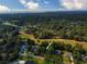 Aerial shot highlighting the property within a golf course community with mature trees and ocean views at 1073 Crooked Oak Dr., Pawleys Island, SC 29585