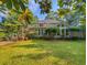 Picturesque backyard with a well-manicured lawn, mature trees, and a charming deck area at 1073 Crooked Oak Dr., Pawleys Island, SC 29585