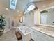 Bright bathroom featuring double sinks, a bathtub with a skylight, and a separate glass door shower at 1073 Crooked Oak Dr., Pawleys Island, SC 29585