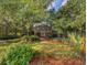 Beautiful brick home with mature trees and a manicured lawn in a serene setting at 1073 Crooked Oak Dr., Pawleys Island, SC 29585