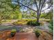 Inviting front porch with potted plants and a view of the landscaped yard and driveway at 1073 Crooked Oak Dr., Pawleys Island, SC 29585
