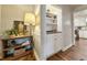Hallway featuring hardwood floors, shelving and a glimpse of the kitchen at 1073 Crooked Oak Dr., Pawleys Island, SC 29585