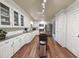 Bright kitchen featuring white cabinets, stainless steel appliances, and wood flooring at 1073 Crooked Oak Dr., Pawleys Island, SC 29585