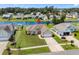 Aerial view of home with green lawn, long driveway, and community lake in the background at 1149 6Th Ave. S, North Myrtle Beach, SC 29582