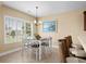 Cozy dining area with stylish chandelier, large window view, and seating for six by the breakfast bar at 1149 6Th Ave. S, North Myrtle Beach, SC 29582