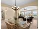 Charming dining area with glass table, wicker chairs, and view to the living room, creating a cozy space at 1149 6Th Ave. S, North Myrtle Beach, SC 29582