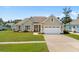 Charming single-story home featuring a well-manicured lawn, two-car garage, and inviting facade at 1149 6Th Ave. S, North Myrtle Beach, SC 29582