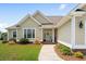 Welcoming home entrance with meticulously landscaped garden and a view of front door with glass at 1149 6Th Ave. S, North Myrtle Beach, SC 29582