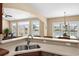 Well-lit kitchen with a breakfast bar, stainless sink, and serene views into the living and dining areas at 1149 6Th Ave. S, North Myrtle Beach, SC 29582
