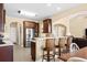 Modern kitchen with breakfast bar, stainless steel refrigerator, and seamless flow to the living area at 1149 6Th Ave. S, North Myrtle Beach, SC 29582