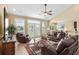Inviting living room with leather furniture, ceiling fan, and abundant natural light from the French doors at 1149 6Th Ave. S, North Myrtle Beach, SC 29582