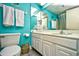 Bright, updated bathroom featuring turquoise walls, white vanity, and ample towel storage at 1207 S Ocean Blvd. # 50809, Myrtle Beach, SC 29577