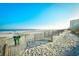 Scenic beach view with a fence, trash can, and buildings in the background at 1207 S Ocean Blvd. # 50809, Myrtle Beach, SC 29577
