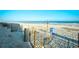 Expansive beach view, featuring beach fence, a clear sky, and calm ocean at 1207 S Ocean Blvd. # 50809, Myrtle Beach, SC 29577