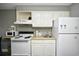 Cozy kitchen featuring essential appliances and white cabinetry for a functional space at 1207 S Ocean Blvd. # 50809, Myrtle Beach, SC 29577
