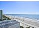 Elevated view captures sandy beach with clear water, showcasing a scenic coastal location at 1207 S Ocean Blvd. # 51012, Myrtle Beach, SC 29577