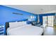 Comfortable bedroom with a plush bed, sofa, balcony access, and soothing blue accents at 1207 S Ocean Blvd. # 51012, Myrtle Beach, SC 29577