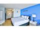 Inviting bedroom with a queen bed, bright blue accent wall, and functional furniture at 1207 S Ocean Blvd. # 51012, Myrtle Beach, SC 29577