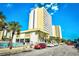Street view of a condo building with a pool, palm trees, and parked cars, showing resort amenities at 1207 S Ocean Blvd. # 51012, Myrtle Beach, SC 29577