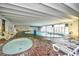 Indoor pool with a hot tub, lounge chairs, and large windows offering natural light at 1207 S Ocean Blvd. # 51012, Myrtle Beach, SC 29577