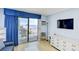 Bright living room with balcony and TV offers modern comforts and scenic views of the beach at 1207 S Ocean Blvd. # 51012, Myrtle Beach, SC 29577