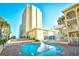 Outdoor pool area with a connected wading pool, poolside seating and the condominium building at 1207 S Ocean Blvd. # 51012, Myrtle Beach, SC 29577