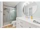 Bathroom showcasing a glass-enclosed shower and a modern vanity with a round mirror and updated fixtures at 1208 River Oaks Dr. # 24-B, Myrtle Beach, SC 29579