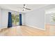 Bright room with sliding glass doors, blue curtains, and light wood floors for a serene living space at 1208 River Oaks Dr. # 24-B, Myrtle Beach, SC 29579