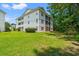 A multi-story building with green grass in the front at 1208 River Oaks Dr. # 24-B, Myrtle Beach, SC 29579