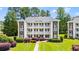 Three story condo building with multiple balconies, brick accents, manicured lawn and shrubs at 1208 River Oaks Dr. # 24-B, Myrtle Beach, SC 29579