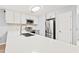 Bright kitchen featuring white cabinets, stainless steel appliances, and a large island with a marble countertop at 1208 River Oaks Dr. # 24-B, Myrtle Beach, SC 29579