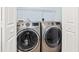 Laundry area featuring modern front-load washer and dryer set, accessible through a white door at 1208 River Oaks Dr. # 24-B, Myrtle Beach, SC 29579