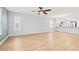 Bright living room with hardwood floors, ceiling fan and transitions to the kitchen area at 1208 River Oaks Dr. # 24-B, Myrtle Beach, SC 29579