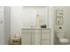 Bright bathroom with white cabinets, neutral walls, and a shower with striped curtains at 1218 Willow Oaks Way, Conway, SC 29526