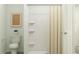 Bright bathroom featuring a shower with curtain, white toilet, and minimalist décor, creating a simple and clean space at 1222 Willow Oaks Way, Conway, SC 29526