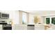 Bright, white kitchen features stainless steel appliances, an island, and an open layout perfect for modern living at 1222 Willow Oaks Way, Conway, SC 29526