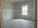 Bright unfinished bedroom with a large window offering natural light at 1236 Mill Banks Dr., Longs, SC 29568
