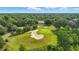 Aerial view of a house on a golf course surrounded by trees at 1259 Oatland Lake Rd., Pawleys Island, SC 29585