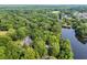 Aerial view of a home surrounded by lush greenery and a body of water at 1259 Oatland Lake Rd., Pawleys Island, SC 29585
